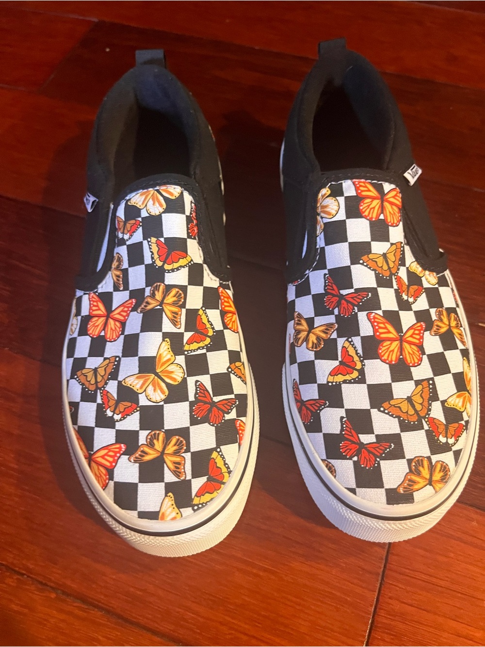Vans Kids Black & White Checkerboard Slip-Ons with Orange Butterfly Print
